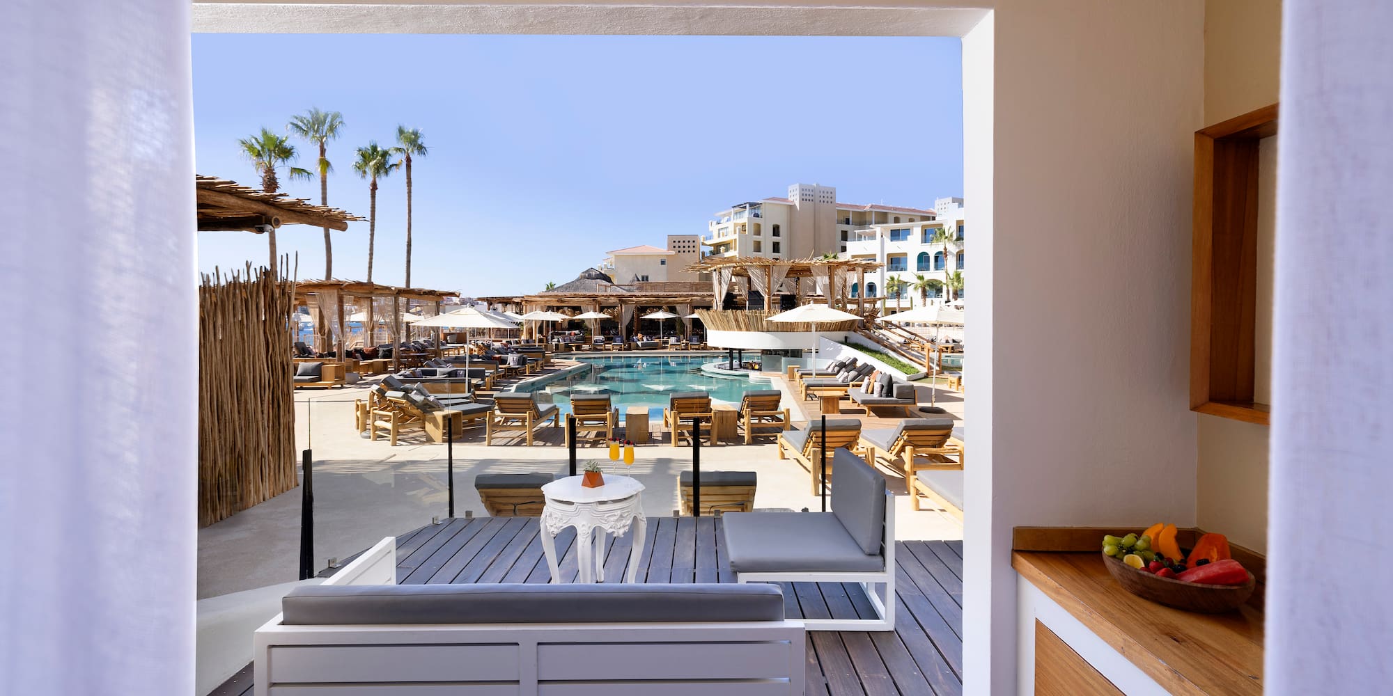 a pool and a patio with chairs and tables