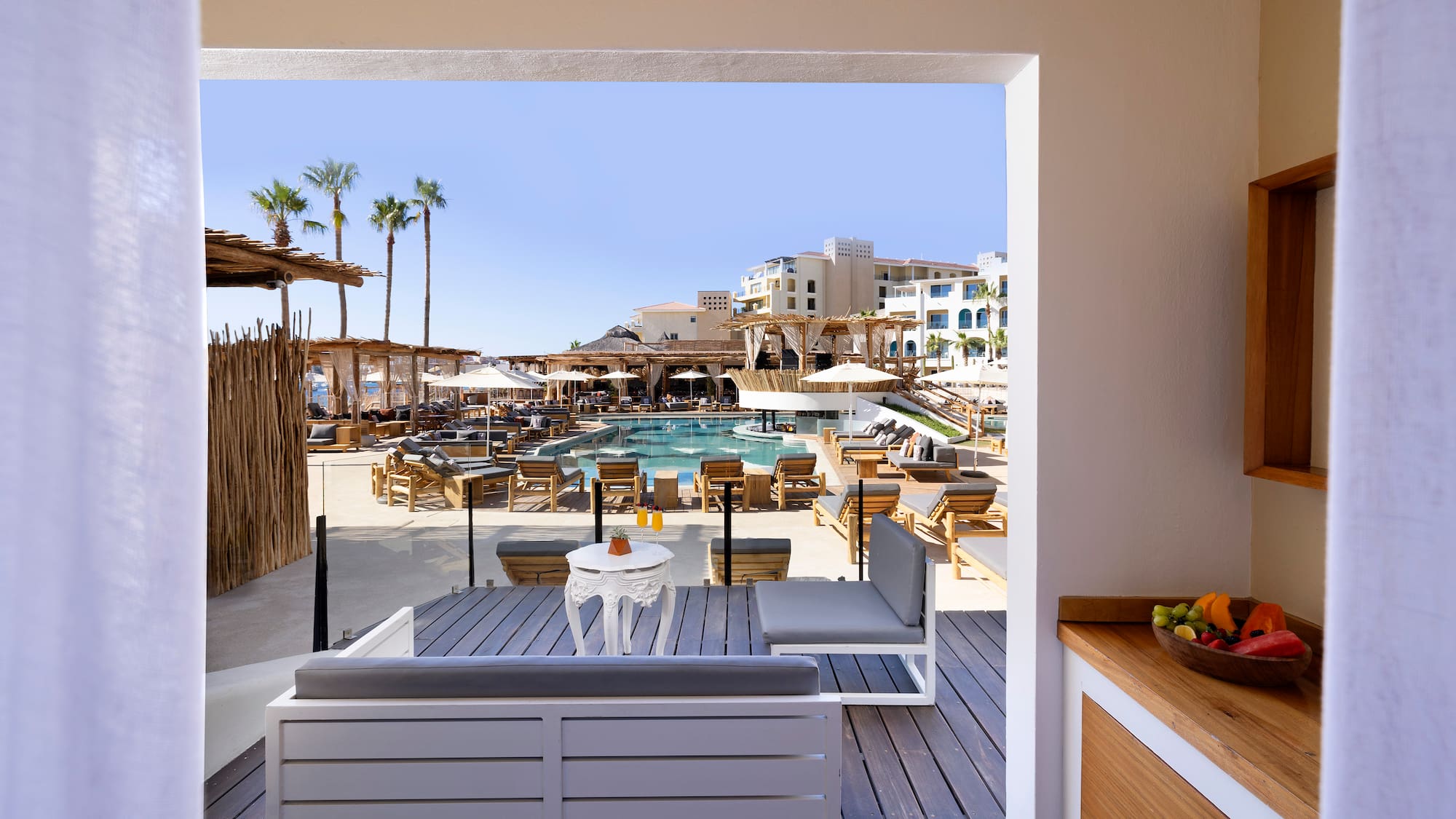 a pool and a patio with chairs and tables