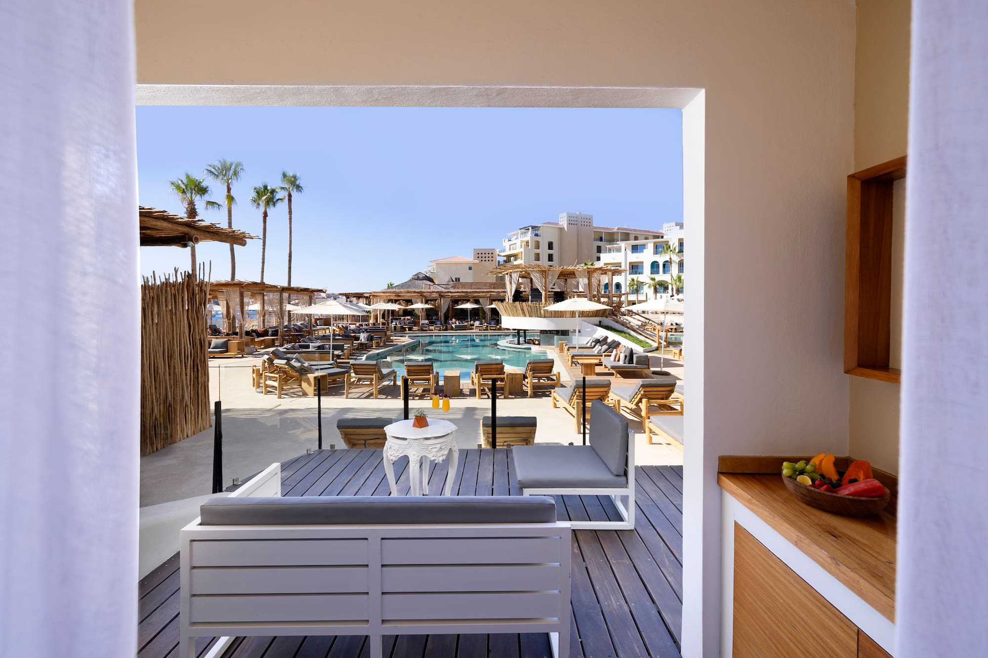 a pool and a patio with chairs and tables