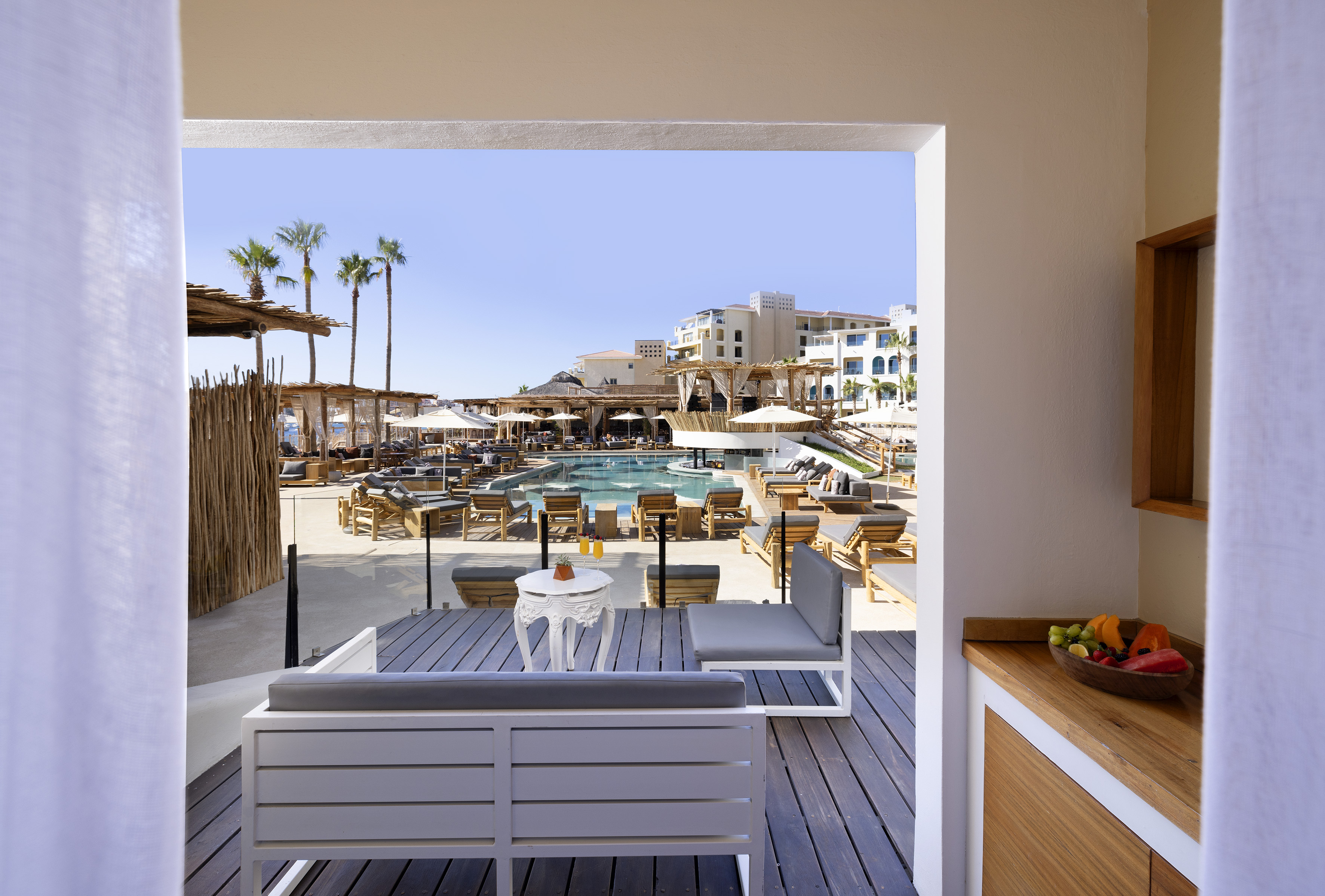 a pool and a patio with chairs and tables