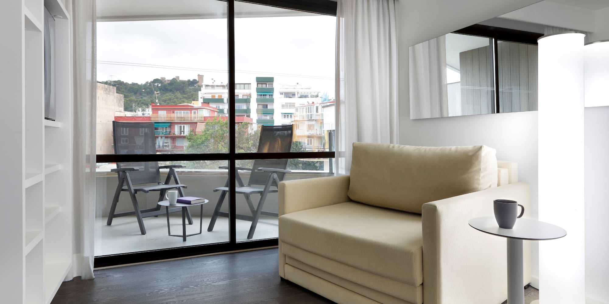 a living room with a couch and a glass door