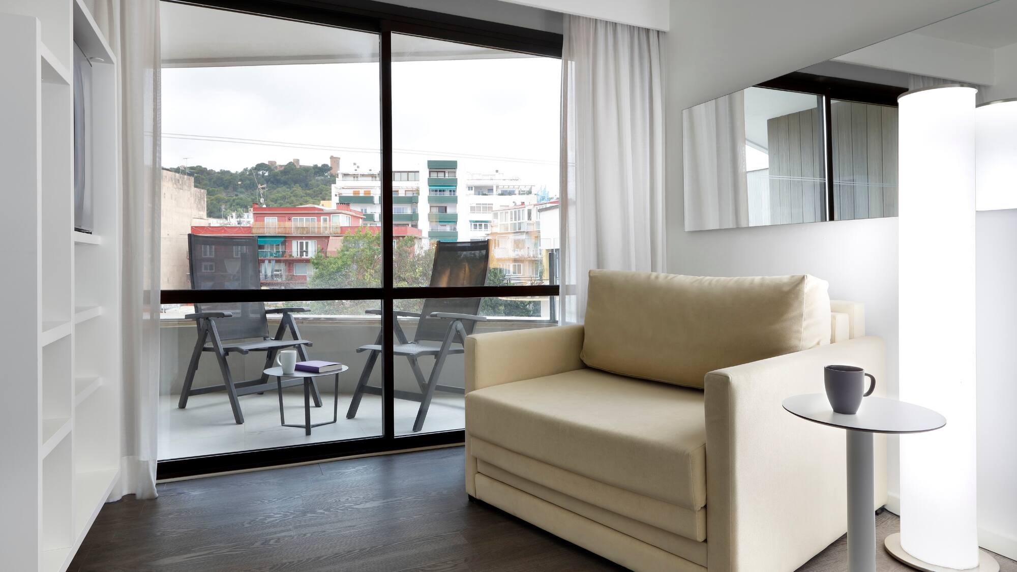 a living room with a couch and a glass door