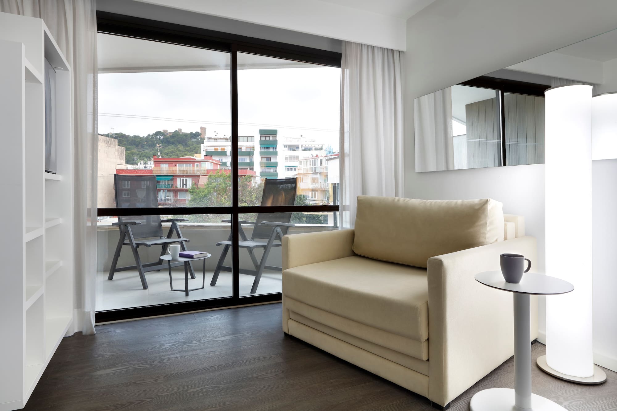 a living room with a couch and a glass door