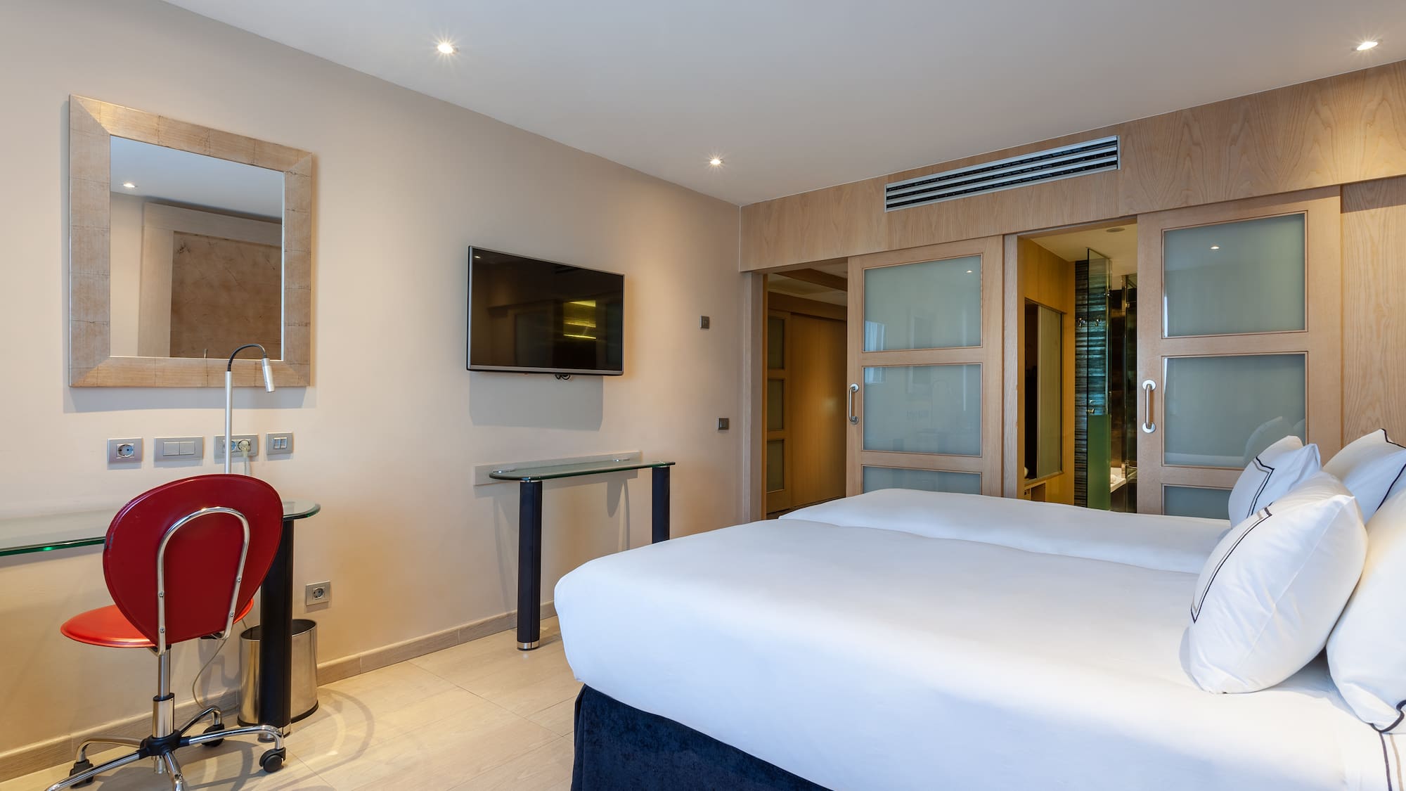 a room with a bed and a desk