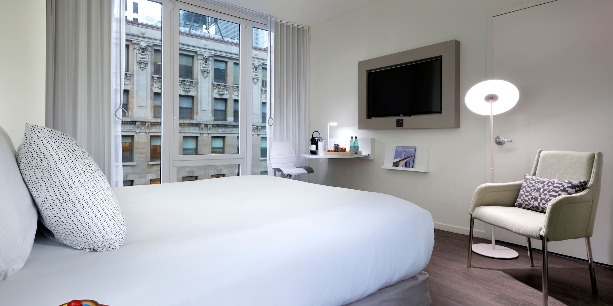 a bedroom with a bed and a television