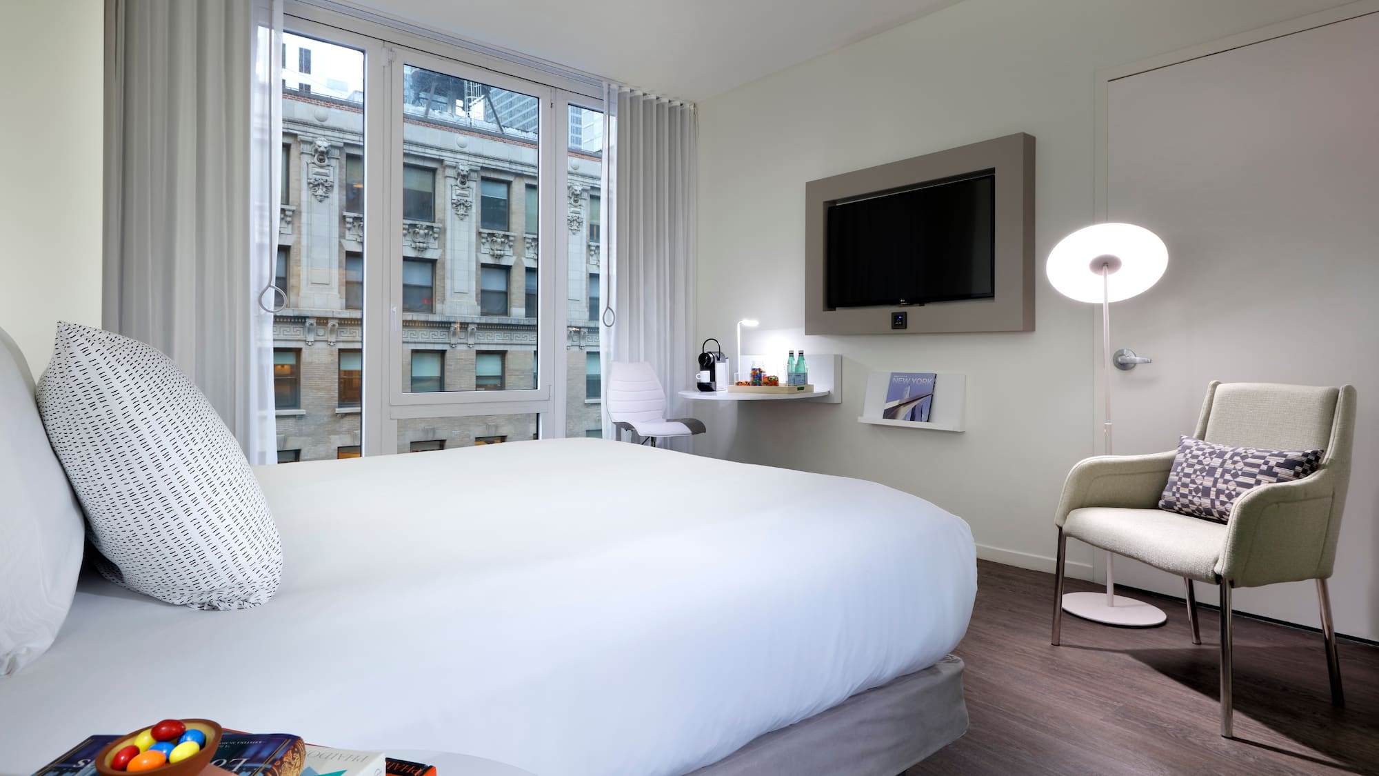 a bedroom with a bed and a television