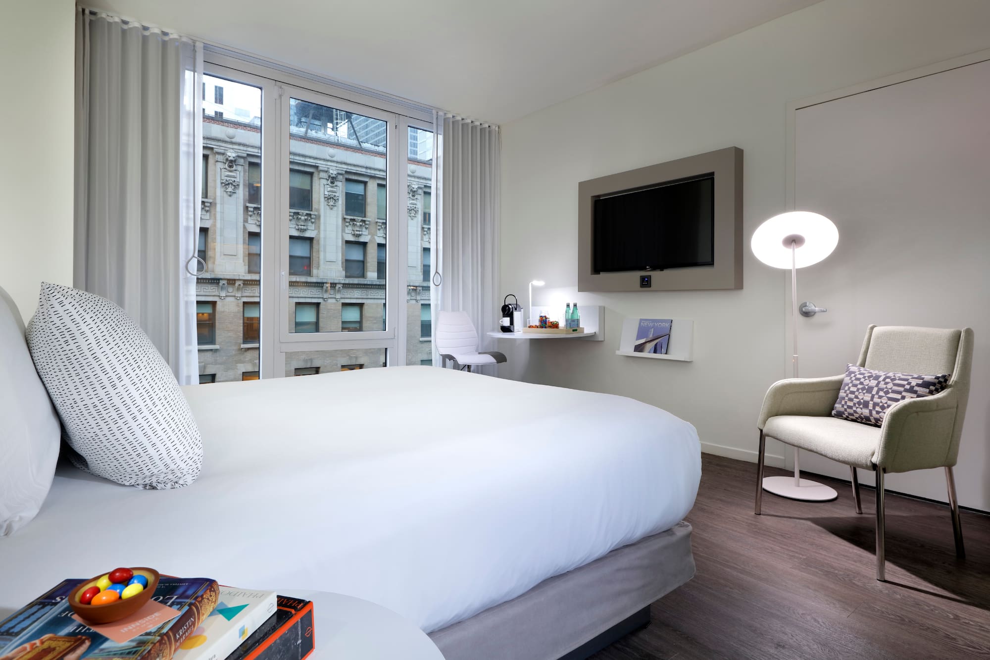 a bedroom with a bed and a television