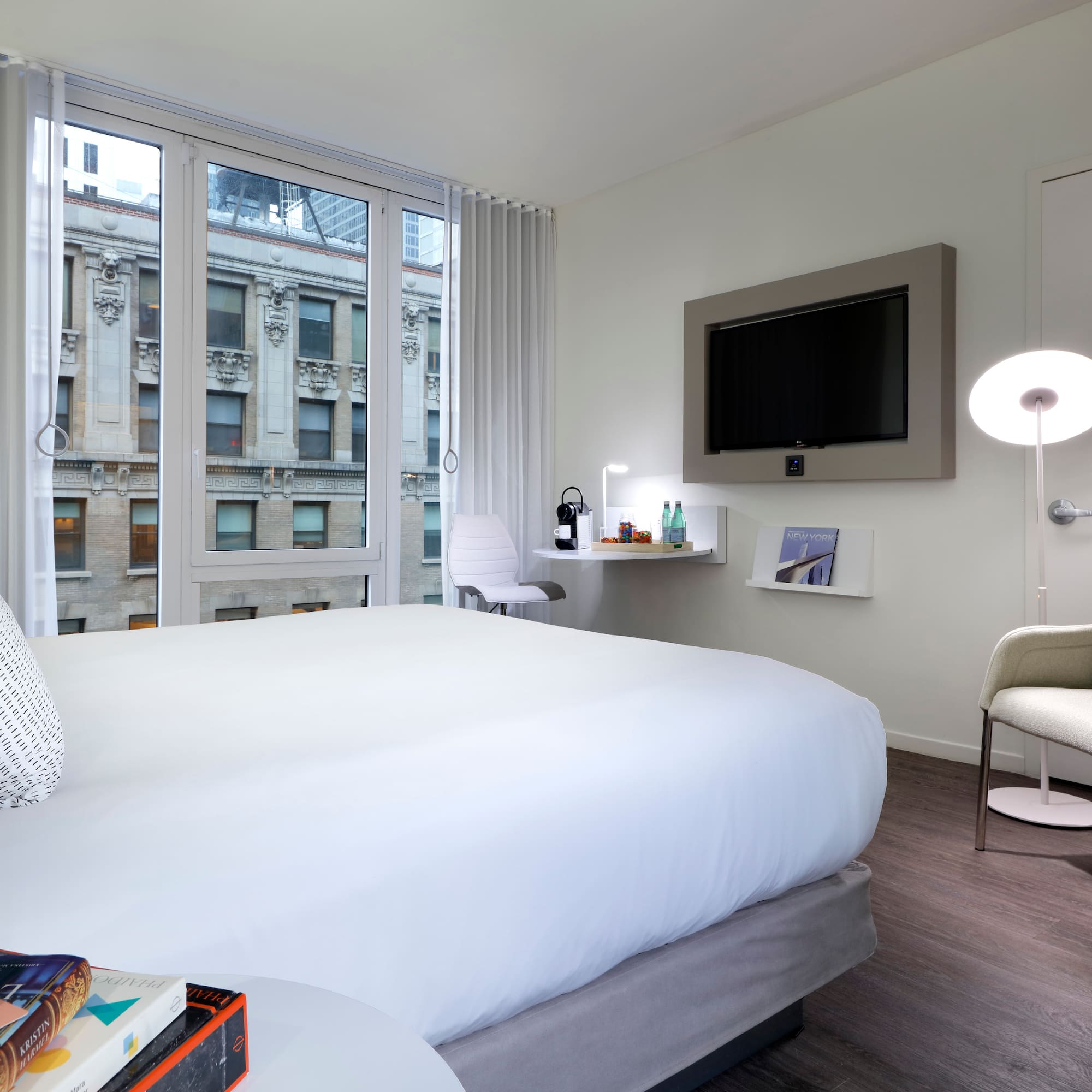 a bedroom with a bed and a television