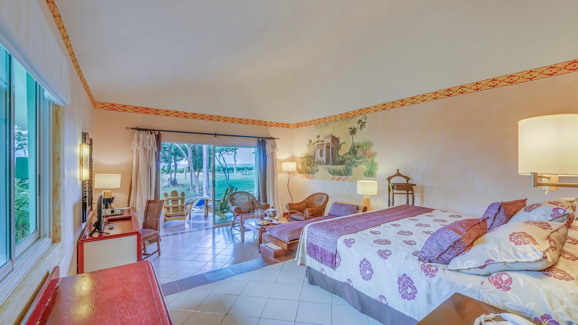 a room with a bed and chairs and a table