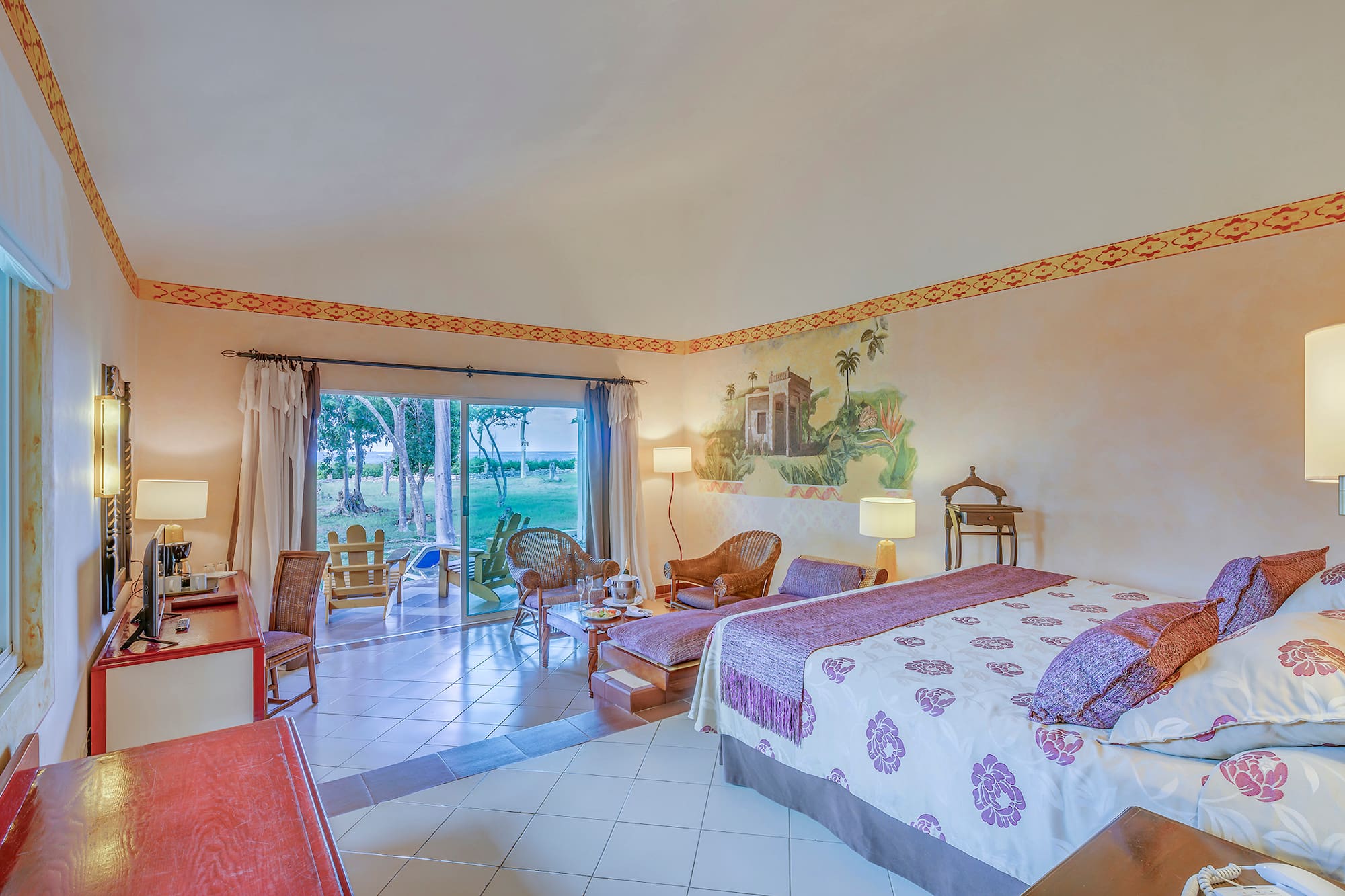 a room with a bed and chairs and a table