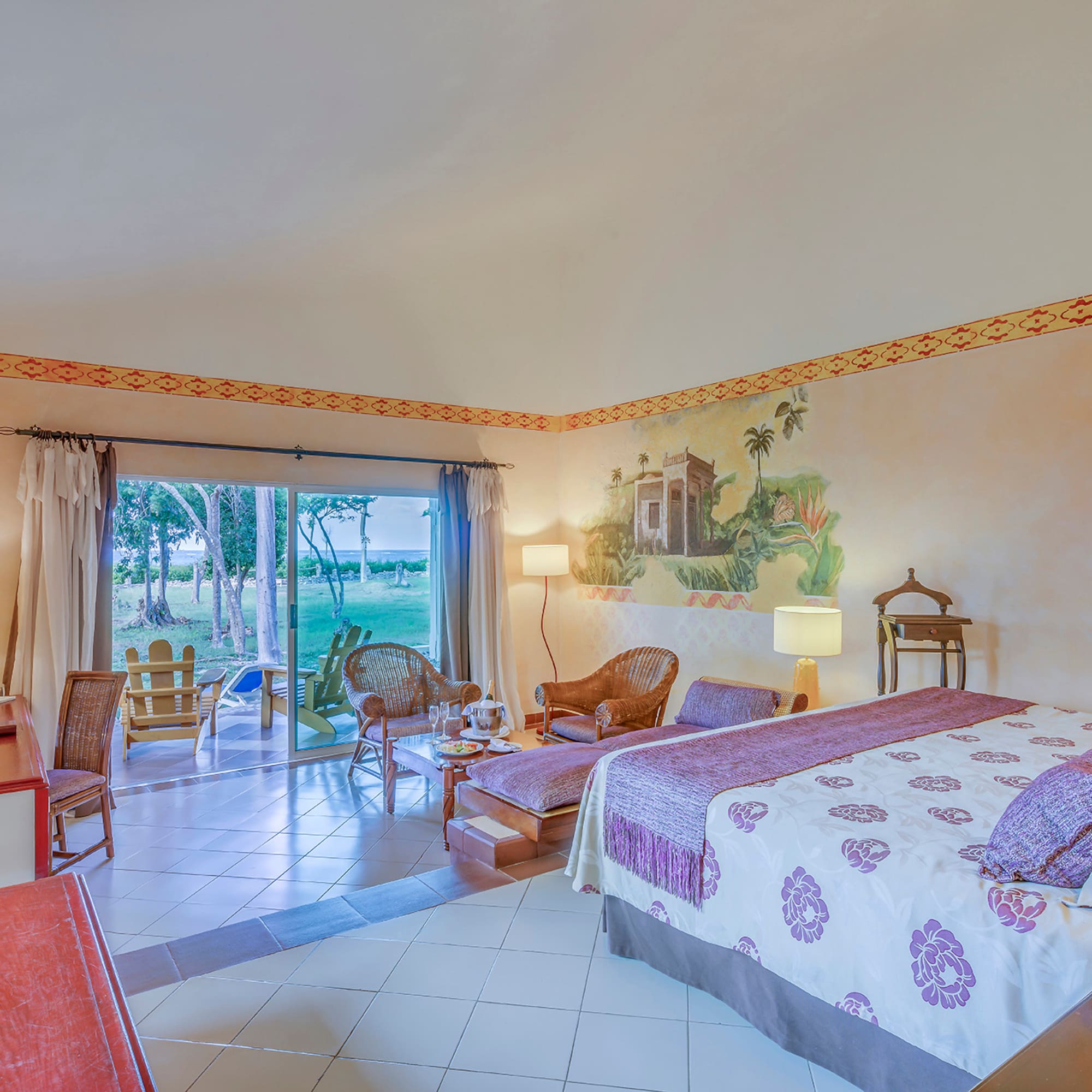 a room with a bed and chairs and a table