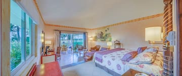 a room with a bed and chairs and a table