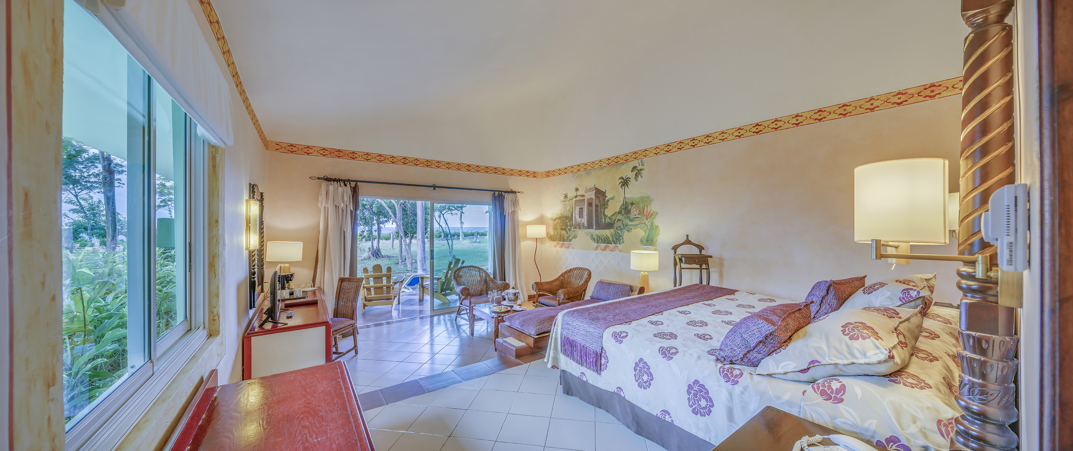 a room with a bed and chairs and a table