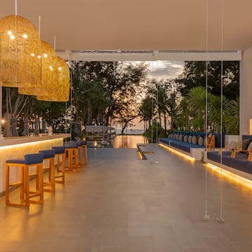 a room with a bar and chairs