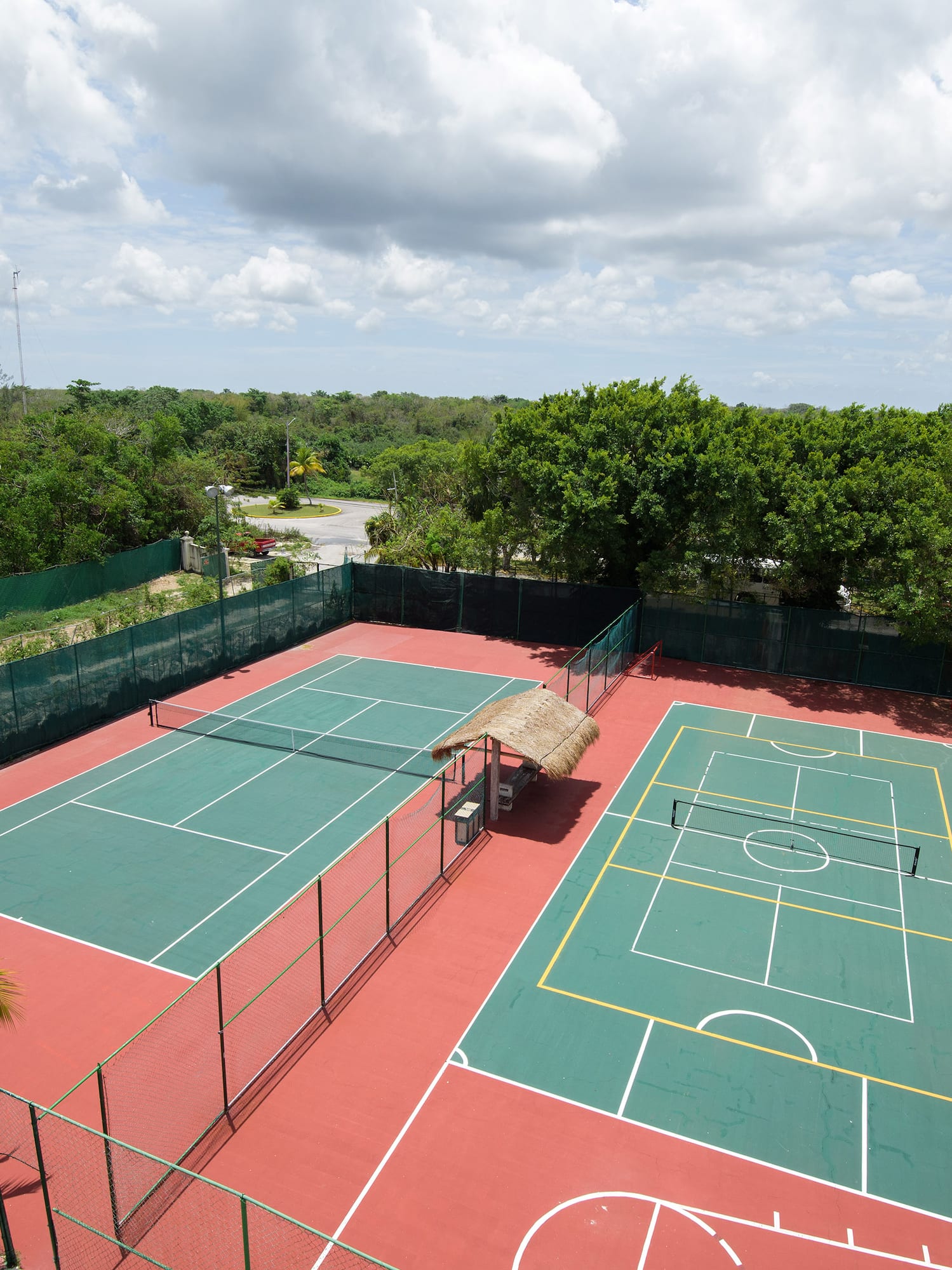 a tennis court with trees in the background