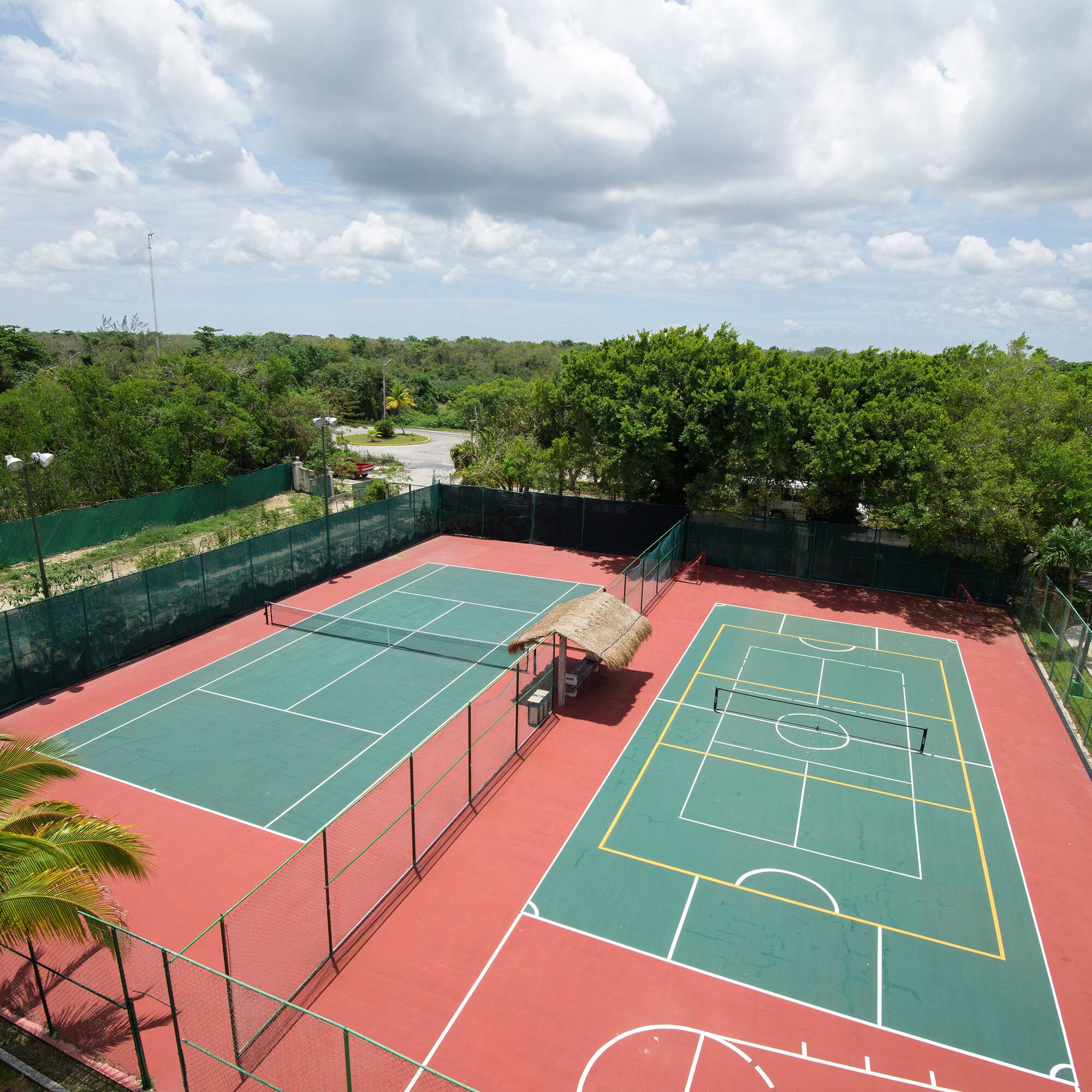 a tennis court with trees in the background
