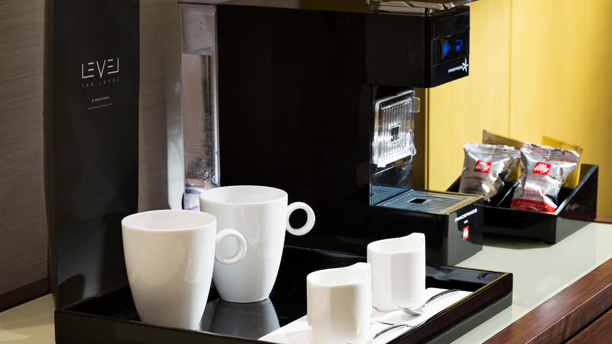 a coffee machine with cups on a tray