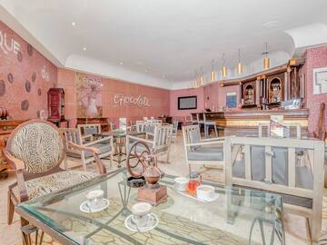 a room with a glass table and chairs