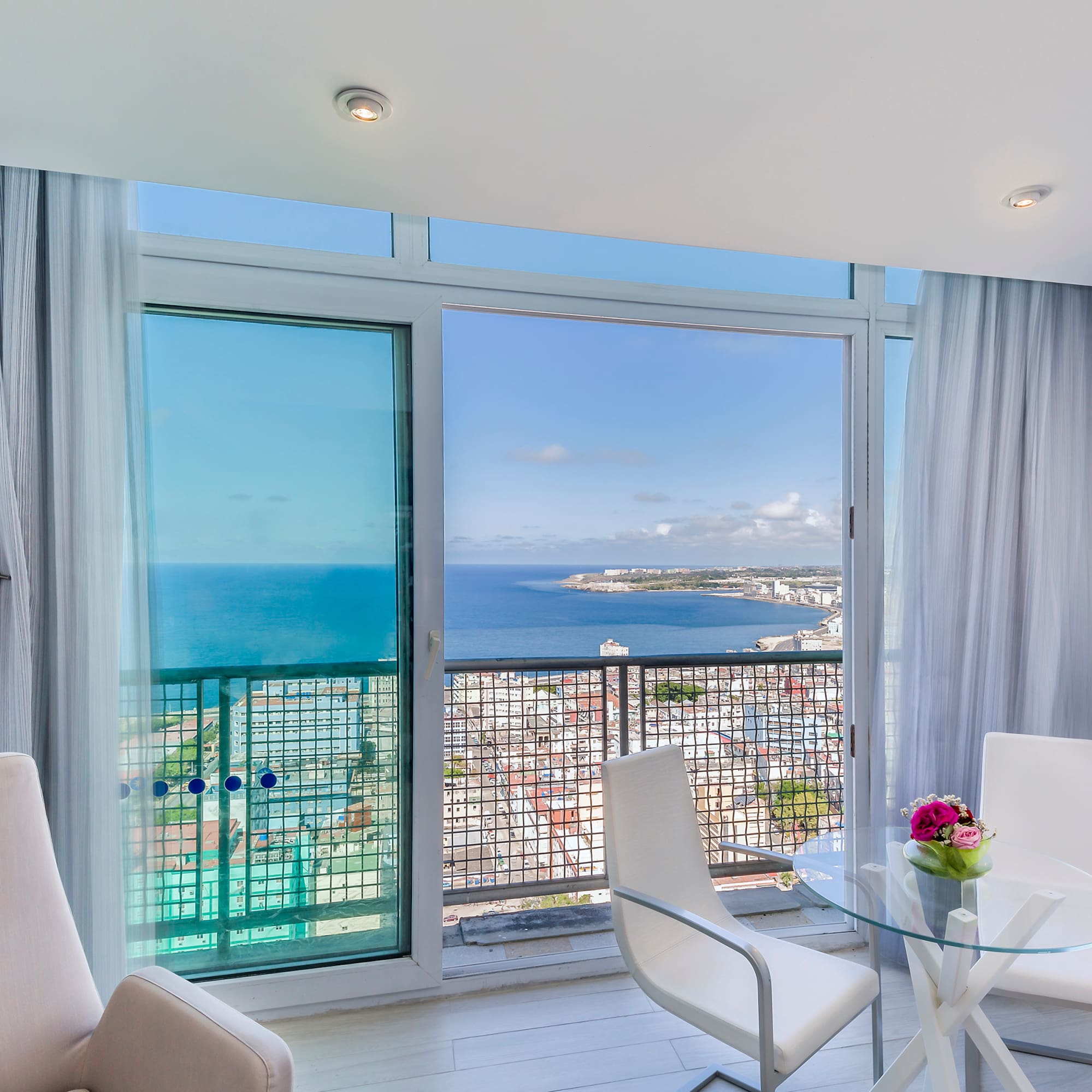 a room with a view of the ocean and a city