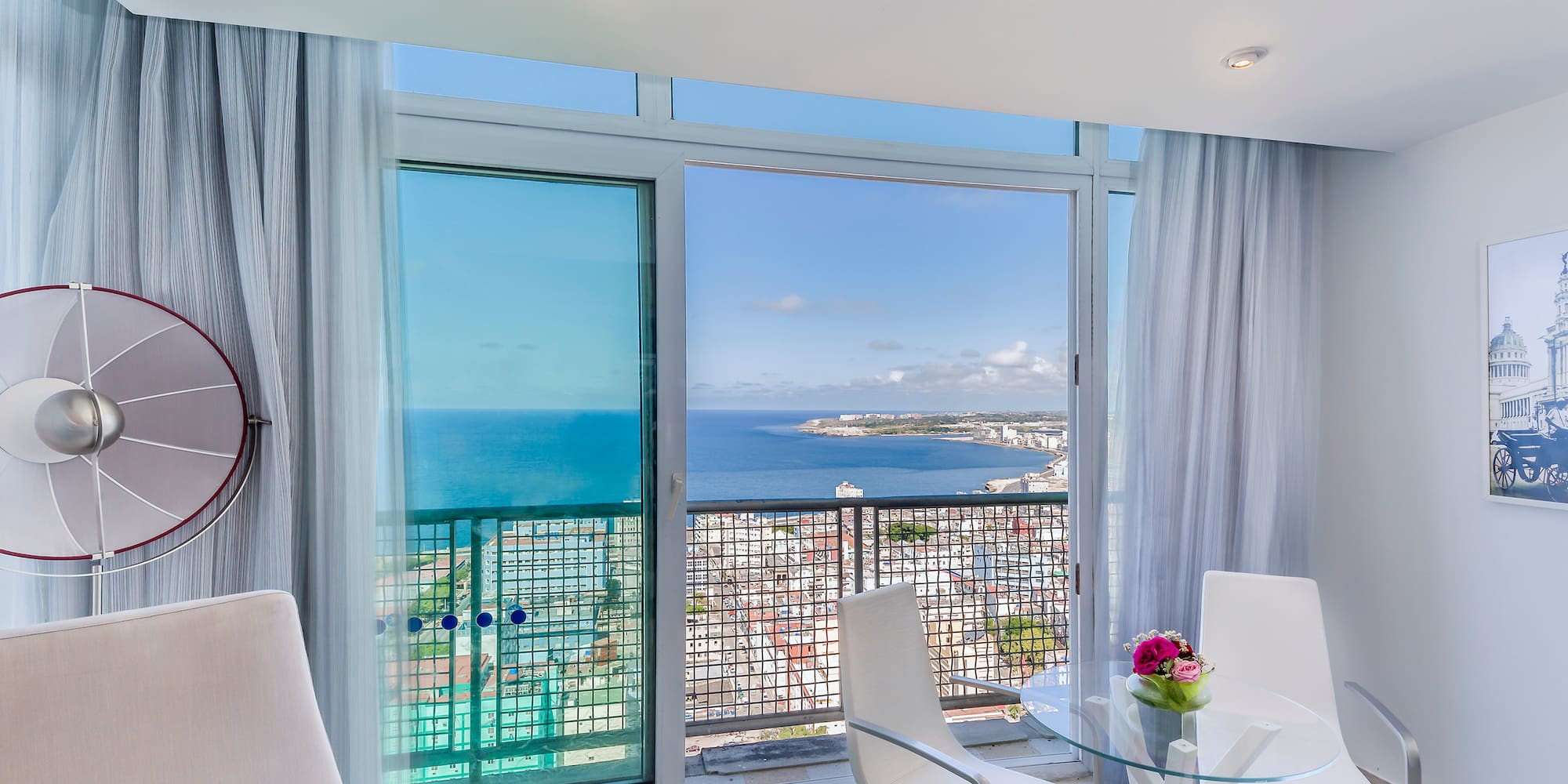 a room with a view of the ocean and a city