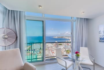 a room with a view of the ocean and a city