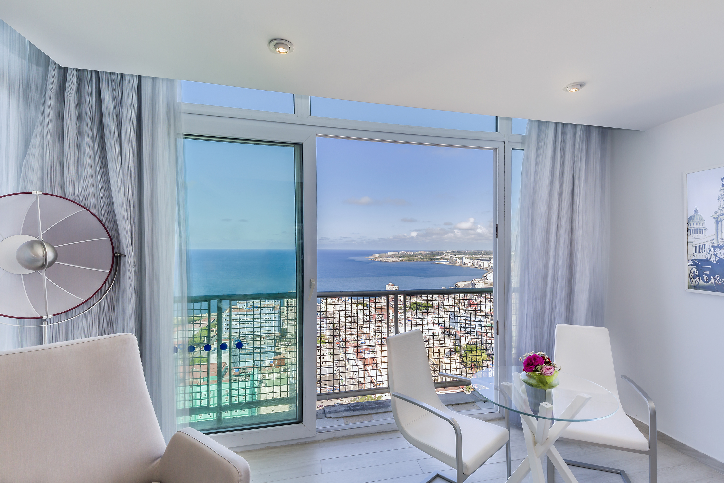 a room with a view of the ocean and a city