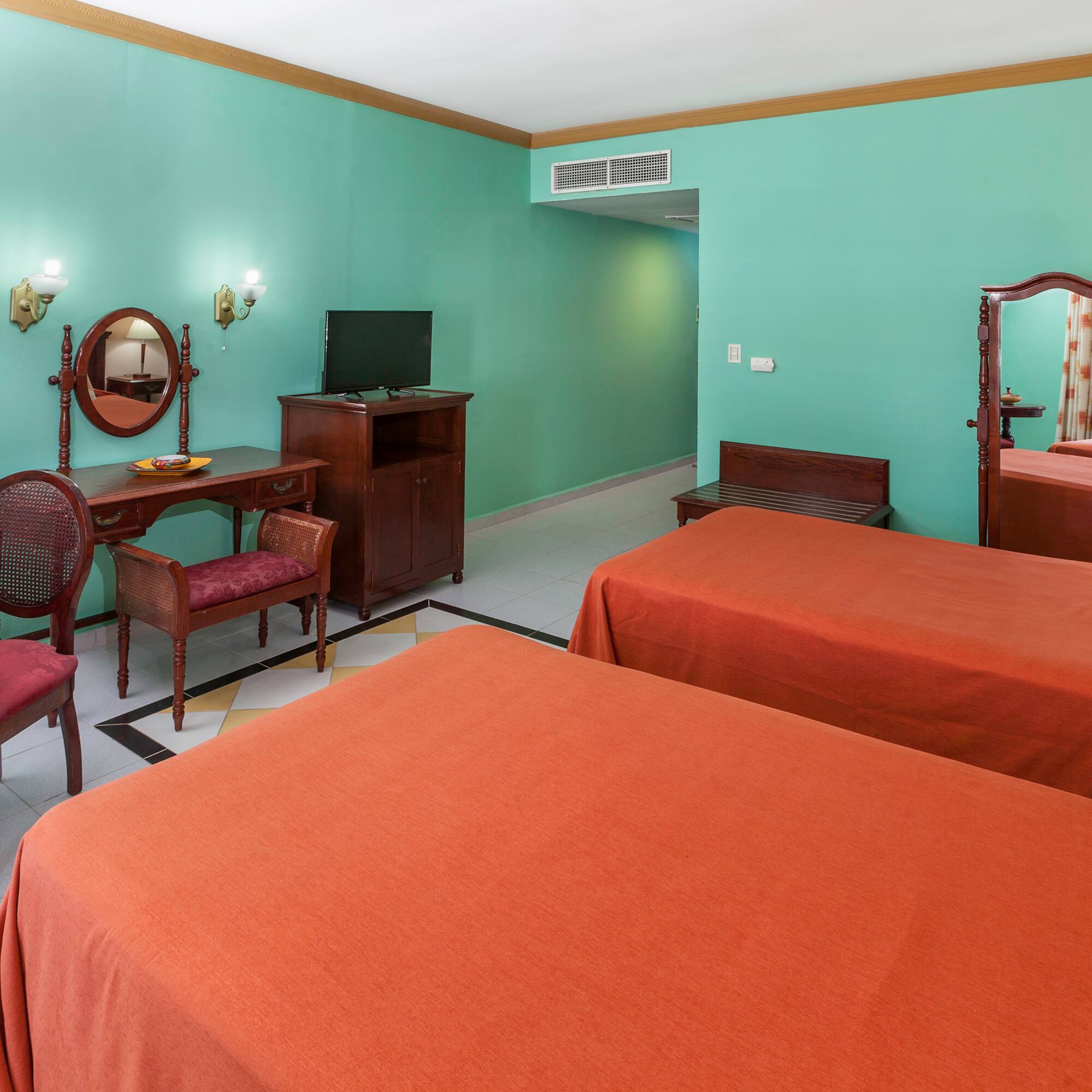 a room with two beds and a mirror