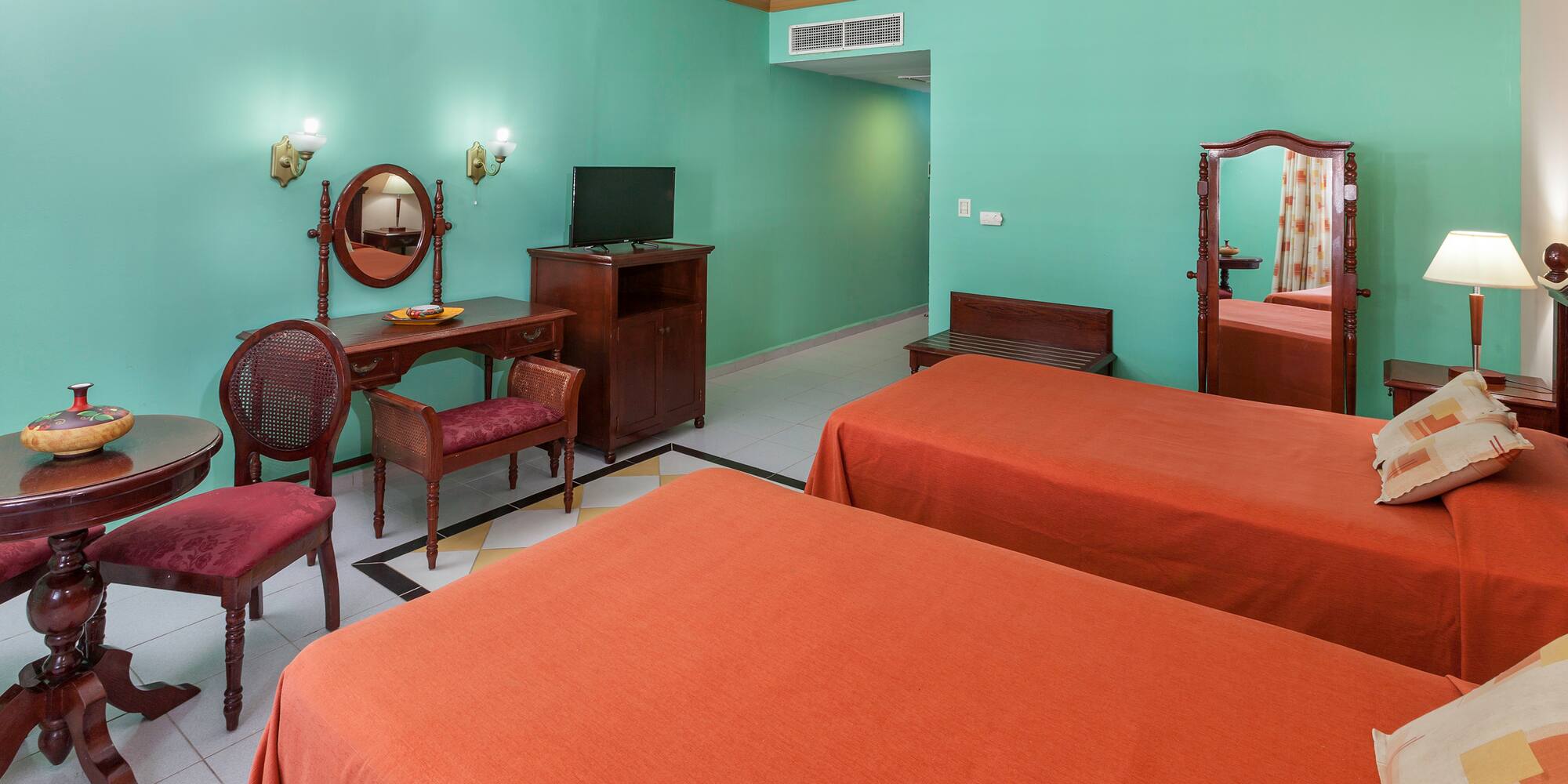 a room with two beds and a mirror