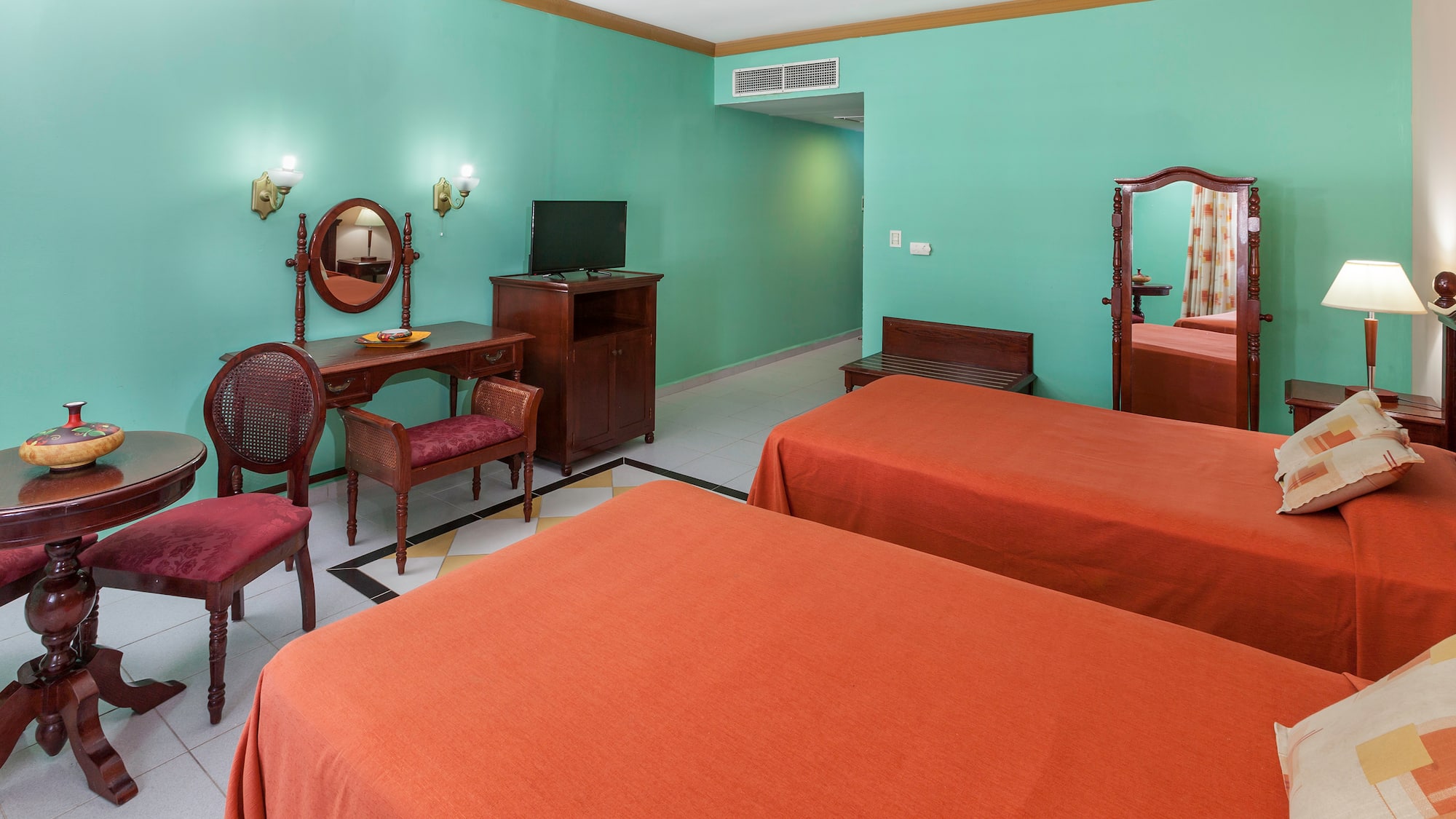 a room with two beds and a mirror