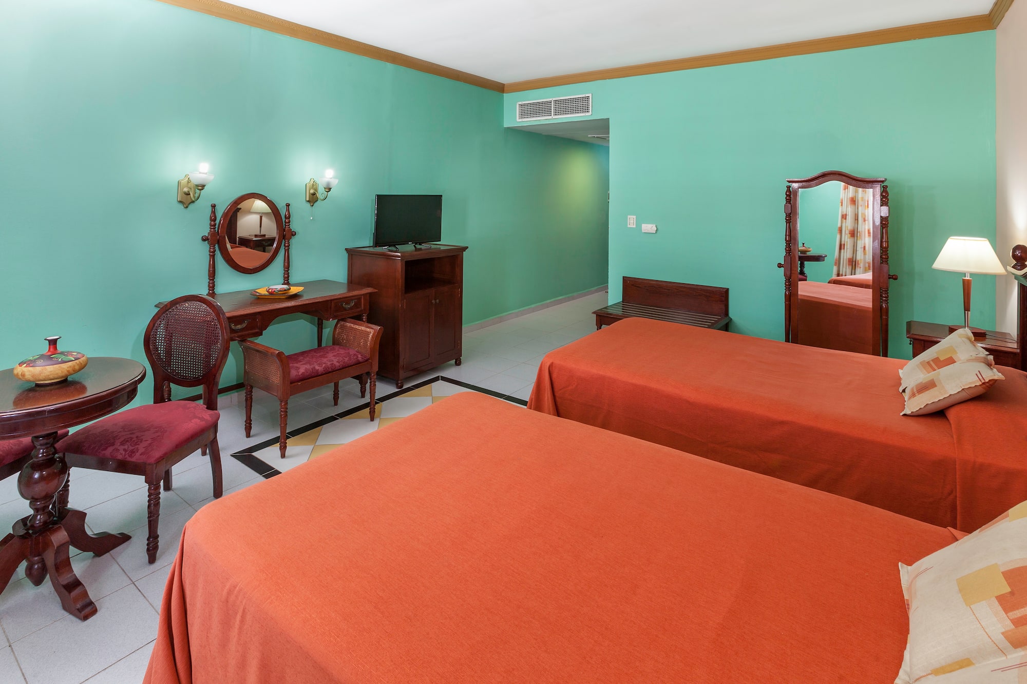 a room with two beds and a mirror