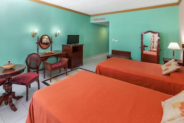 a room with two beds and a mirror