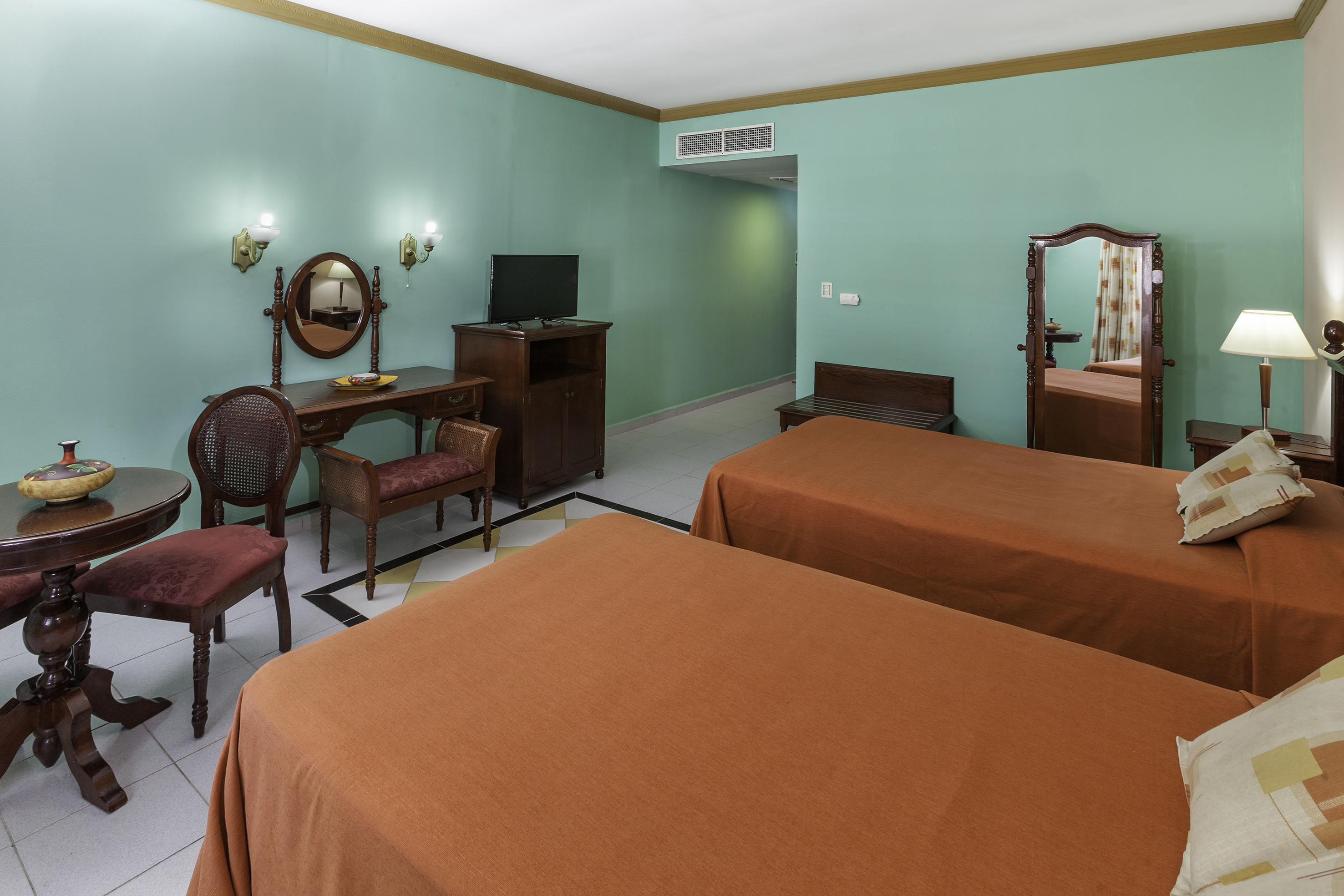 a room with two beds and a mirror