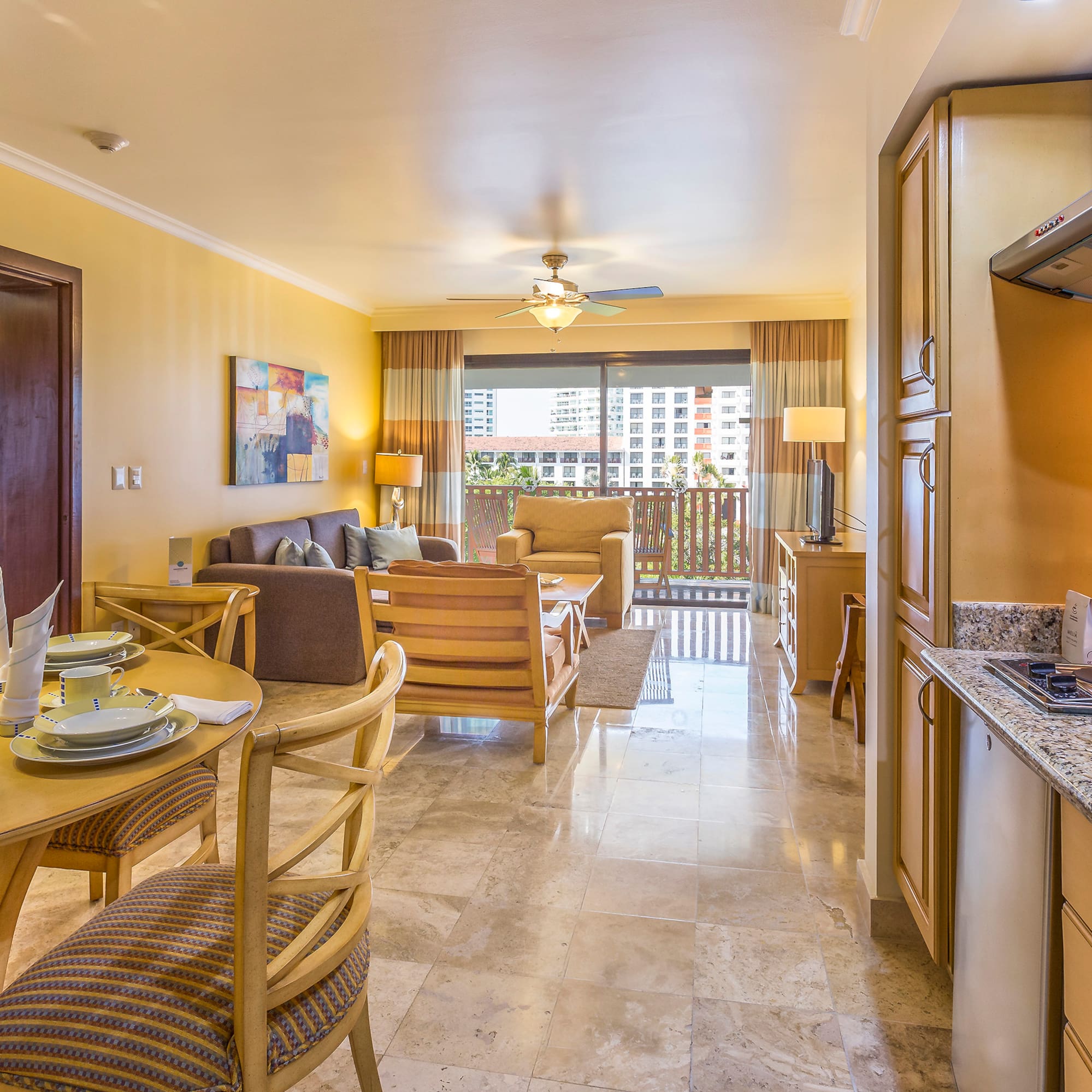 a living room with a kitchen and dining area