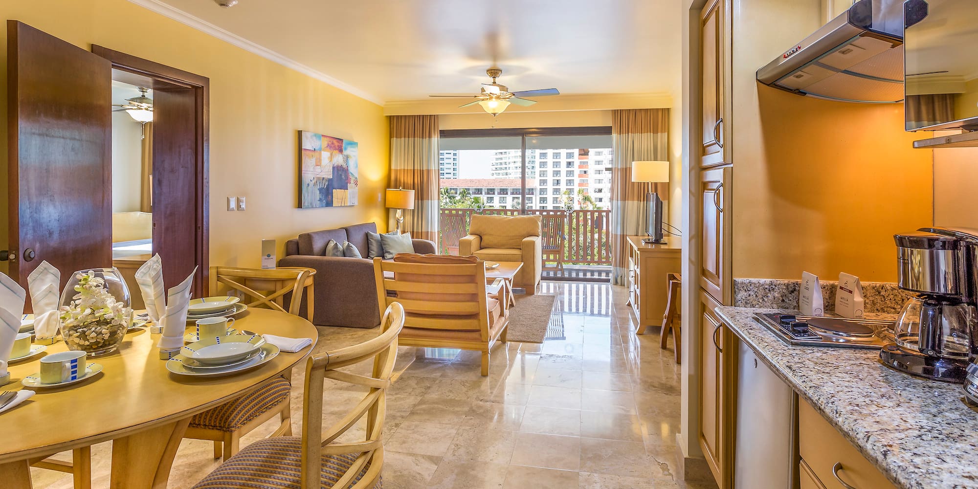 a living room with a kitchen and dining area