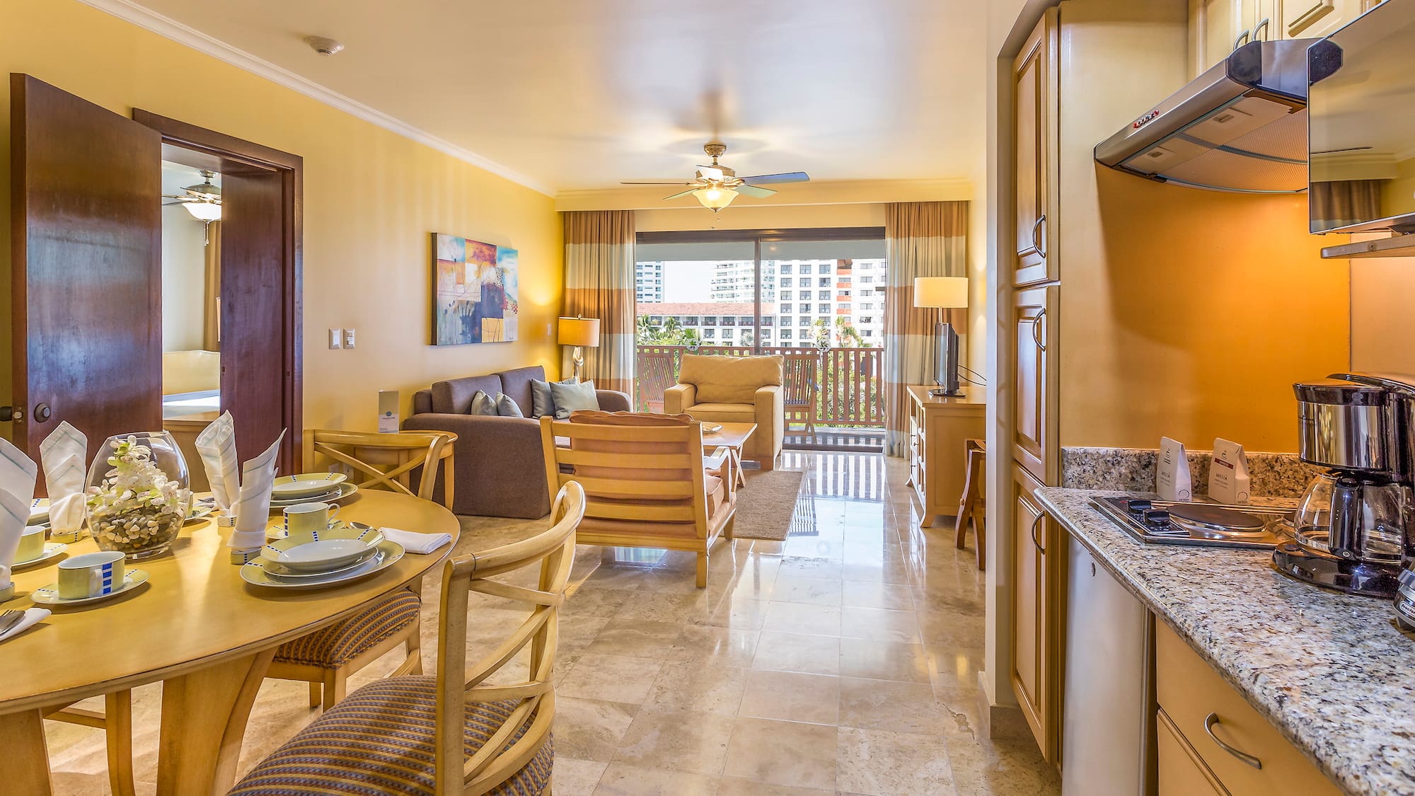 a living room with a kitchen and dining area