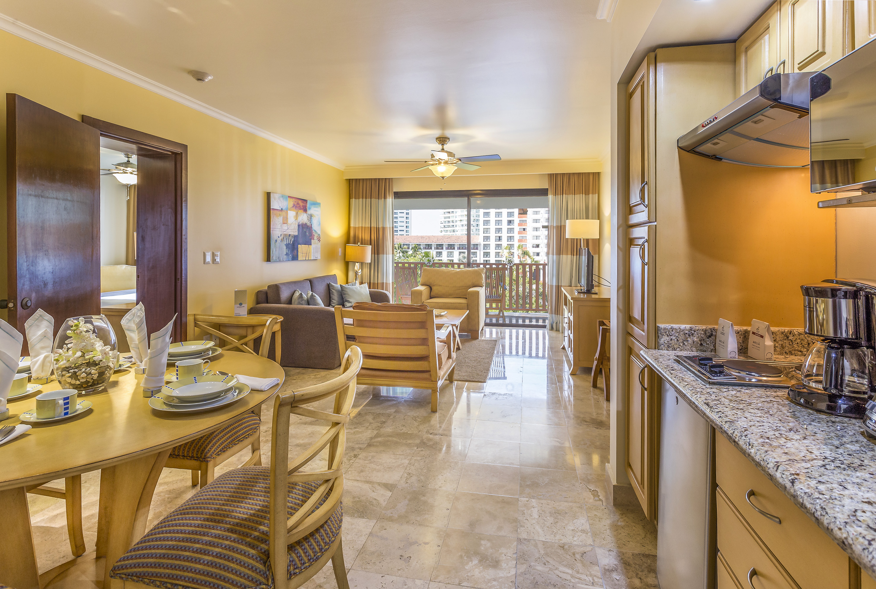 a living room with a kitchen and dining area