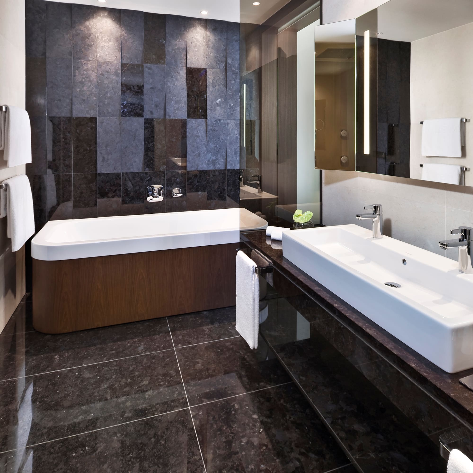 a bathroom with a bathtub and a mirror