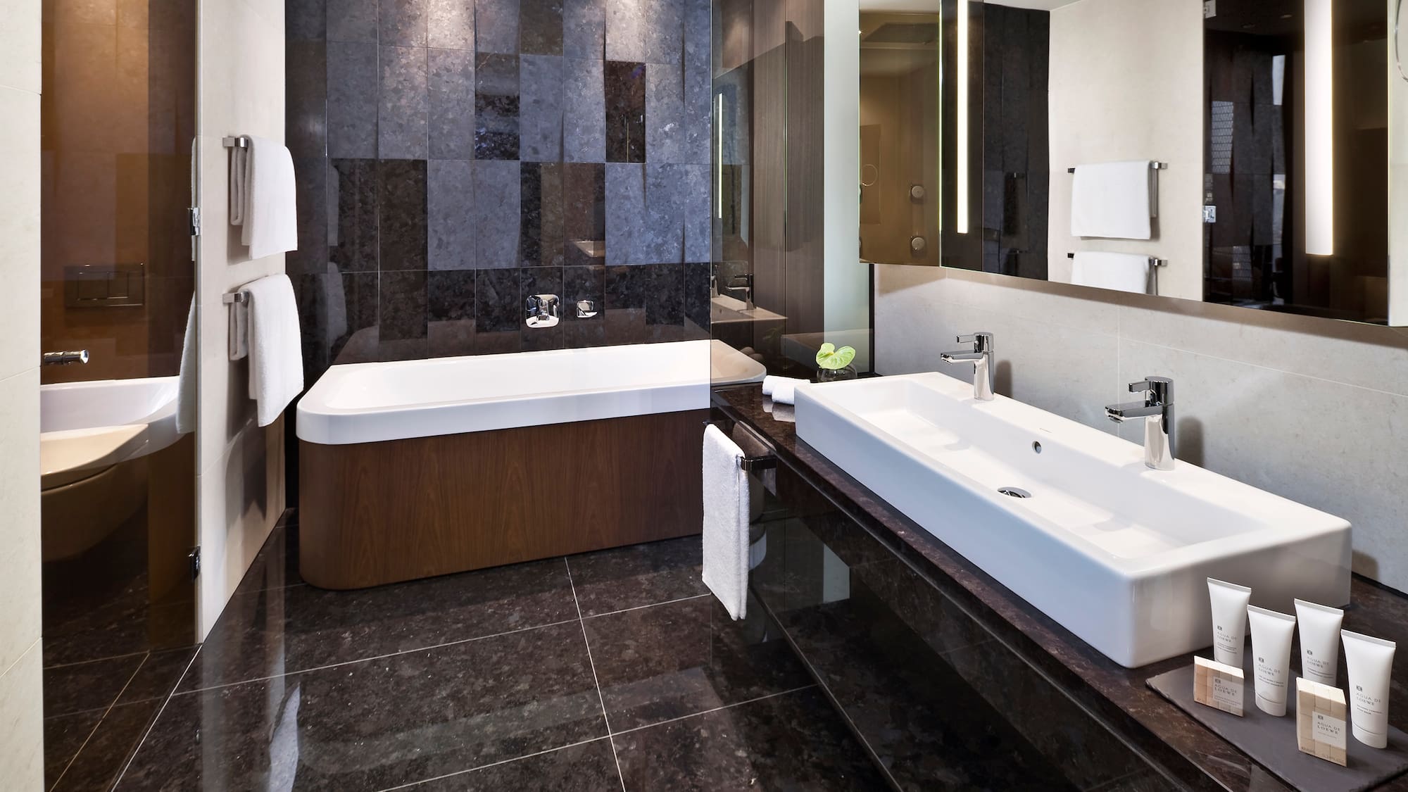 a bathroom with a bathtub and a mirror