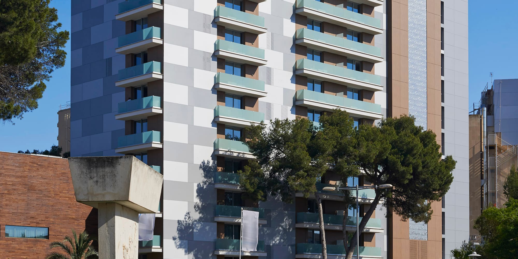 a building with trees and cars in front of it