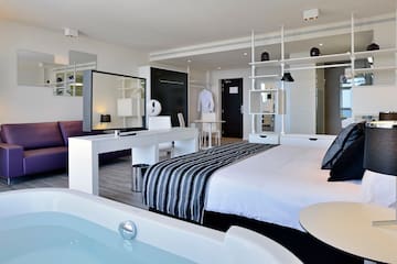 a room with a bed and a bathtub
