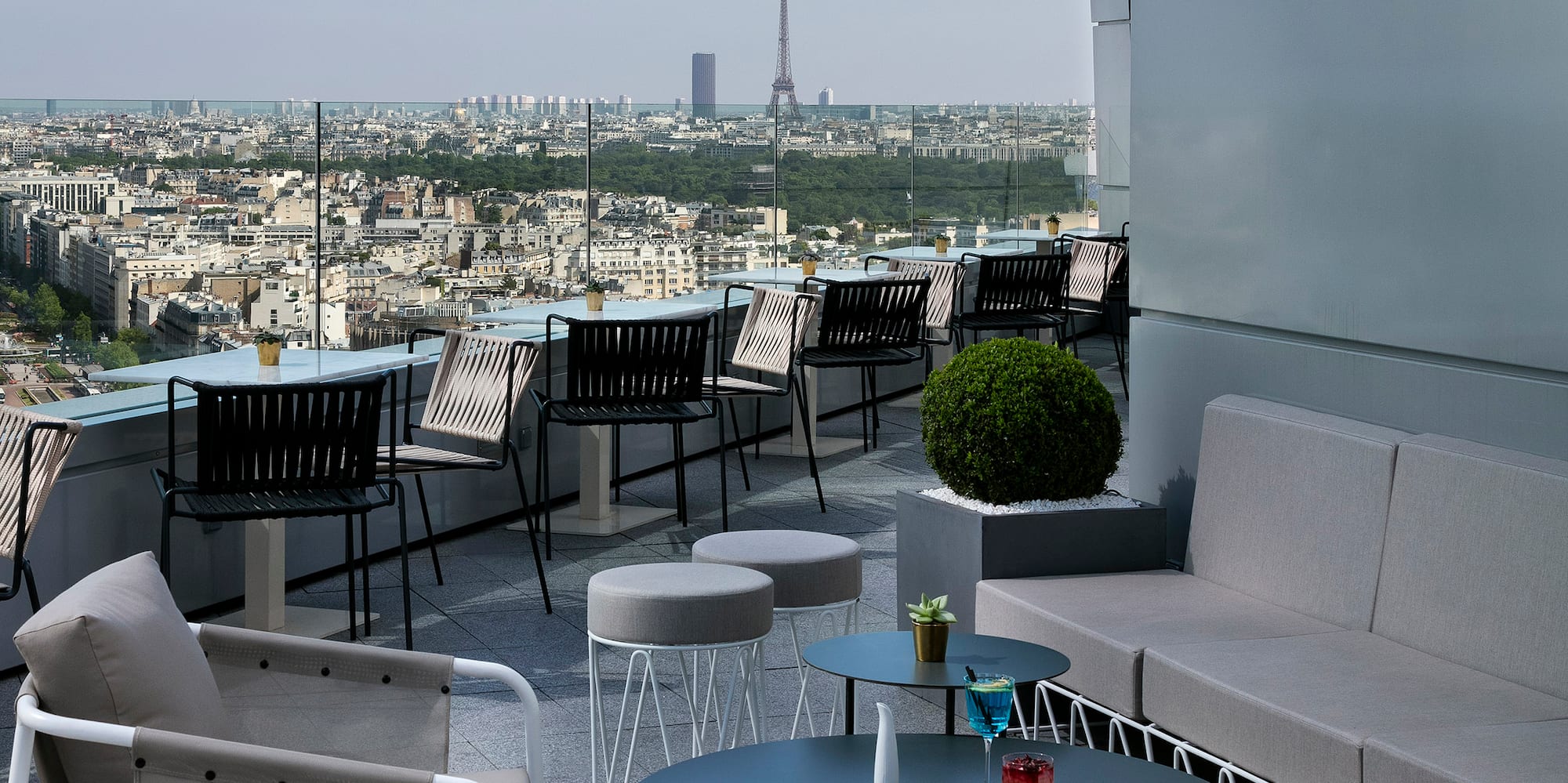 a rooftop patio with a view of a city