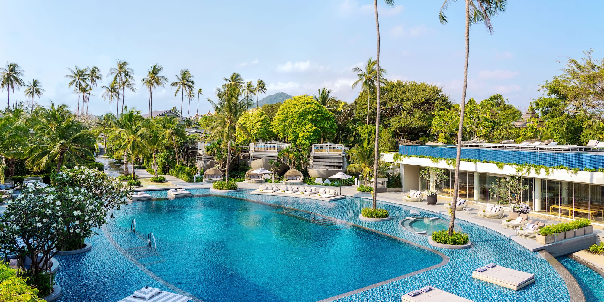 a swimming pool with lounge chairs and trees
