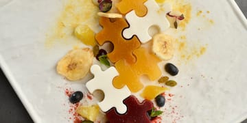 a plate of food with pieces of puzzle