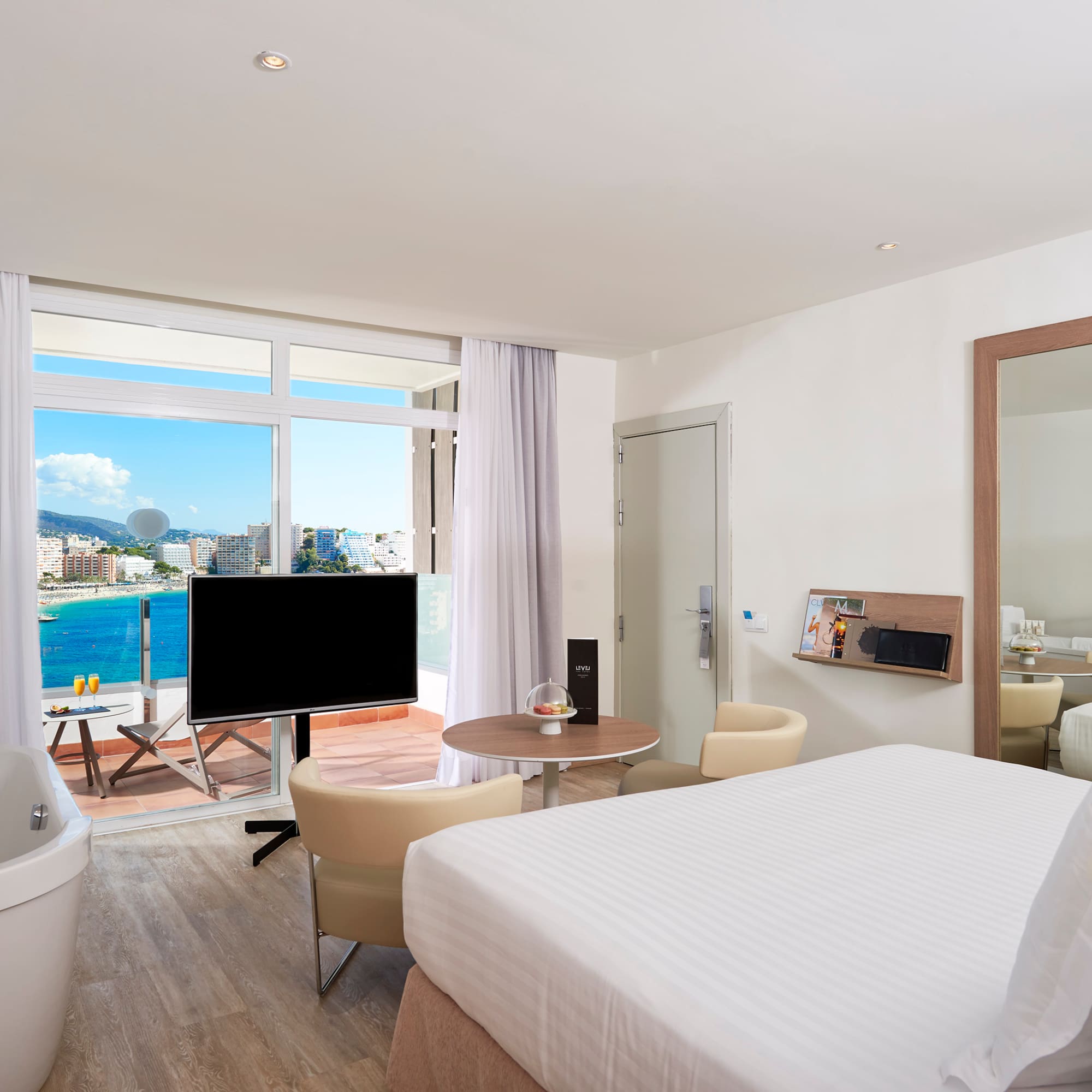 a room with a large window and a large bed