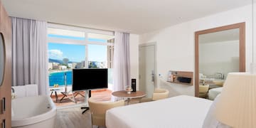 a room with a large window and a large bed
