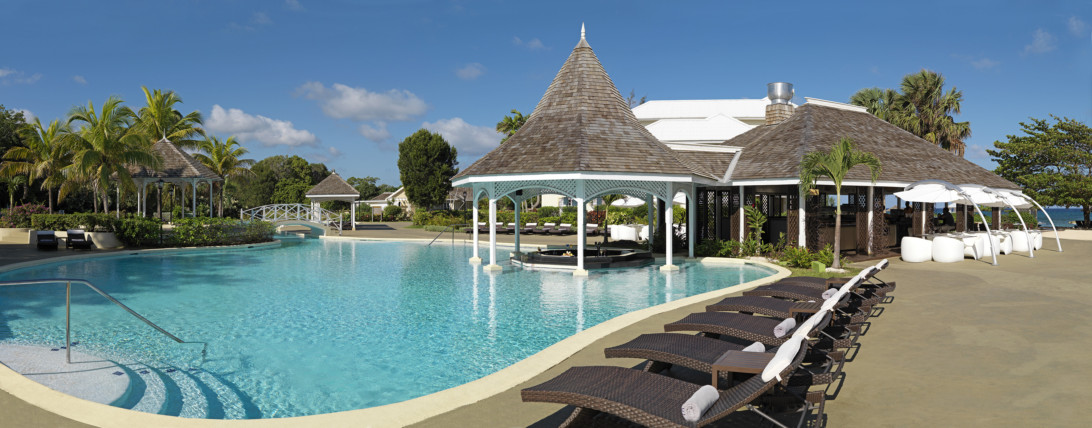 a pool with lounge chairs and a gazebo