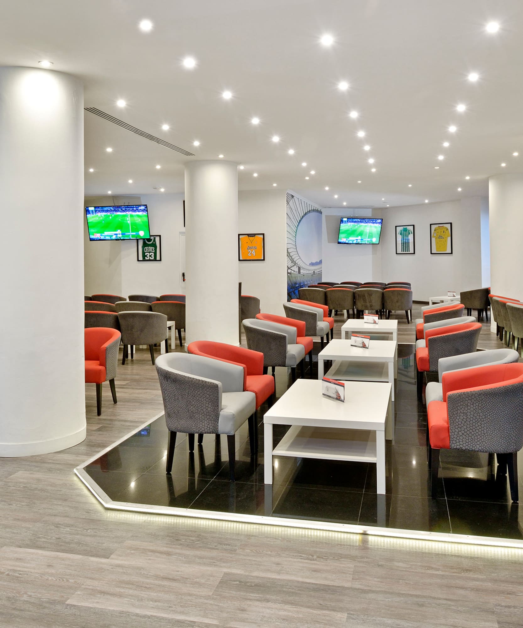 a room with white columns and tables and chairs