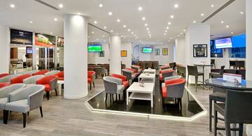 a room with white columns and tables and chairs