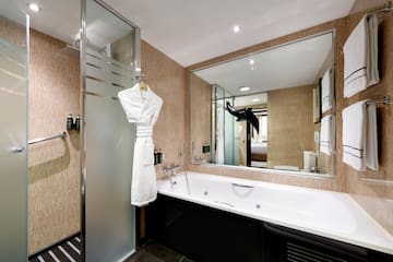 a bathroom with a bathtub and a shower