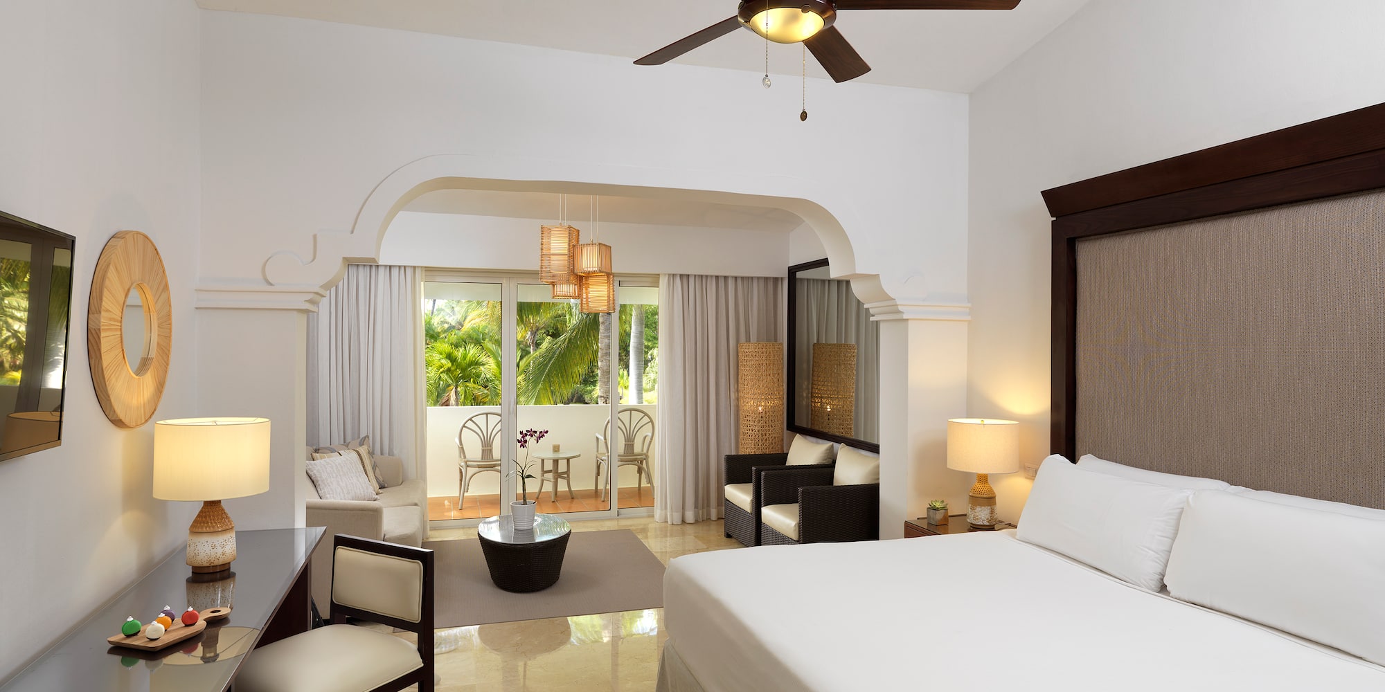 a room with a bed and a ceiling fan